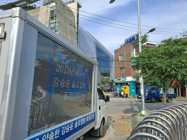 Truck demonstration is being held in front of YG company building by a Chinese f