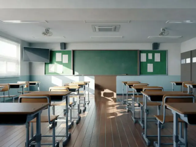 "Here goes, teacher." A high school girl gives her teacher tangerines that have been sprayed with insecticide. (Korea)