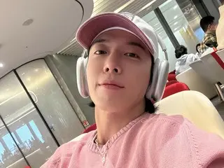 CNBLUE's Yong Hwa greets Lunar New Year from the airport lounge...Looks good in pink sweater