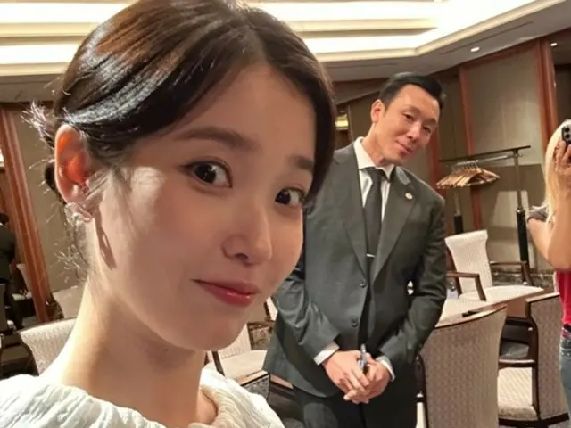 IU and her personal bodyguard share a playful photo